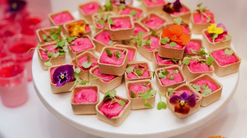 Beetroot hummus tartlets with fresh herbs and edible flowers for Adelaide event catering