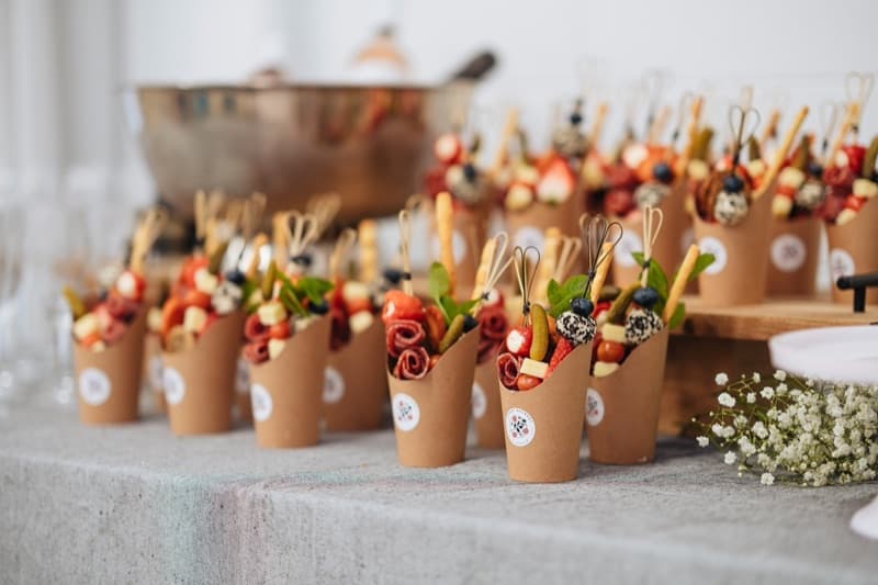 Rows of branded Event Gourmet grazing cups with baby's breath and copper bowl backdrop at an Adelaide cocktail event