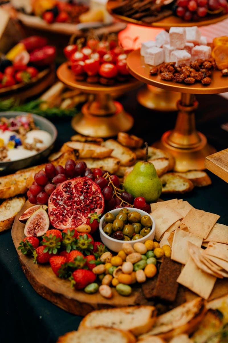 Adelaide grazing display with pomegranate and gold stands styled by Event Gourmet