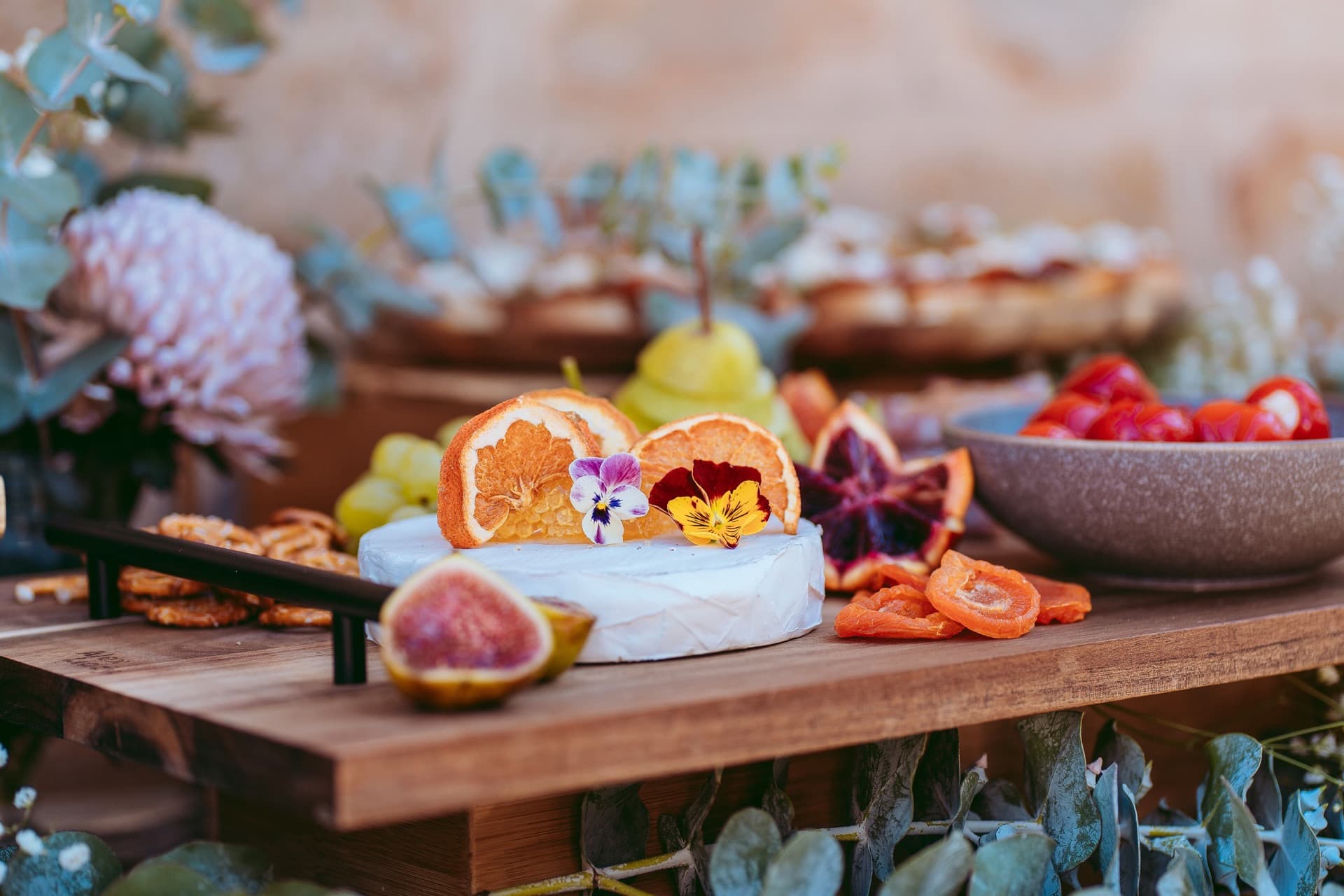 Artisan cheese board styled with fresh flowers by Adelaide caterer Event Gourmet