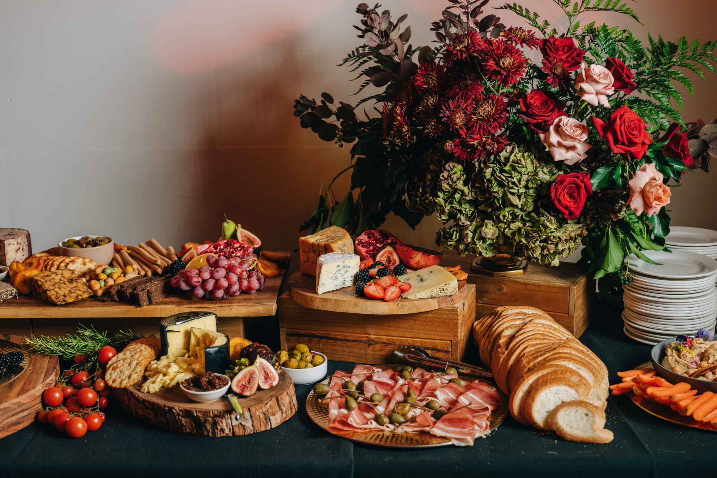 Lavish Adelaide grazing table with charcuterie, cheeses, fresh figs and a centrepiece of red roses, blush roses and dried hydrangea
