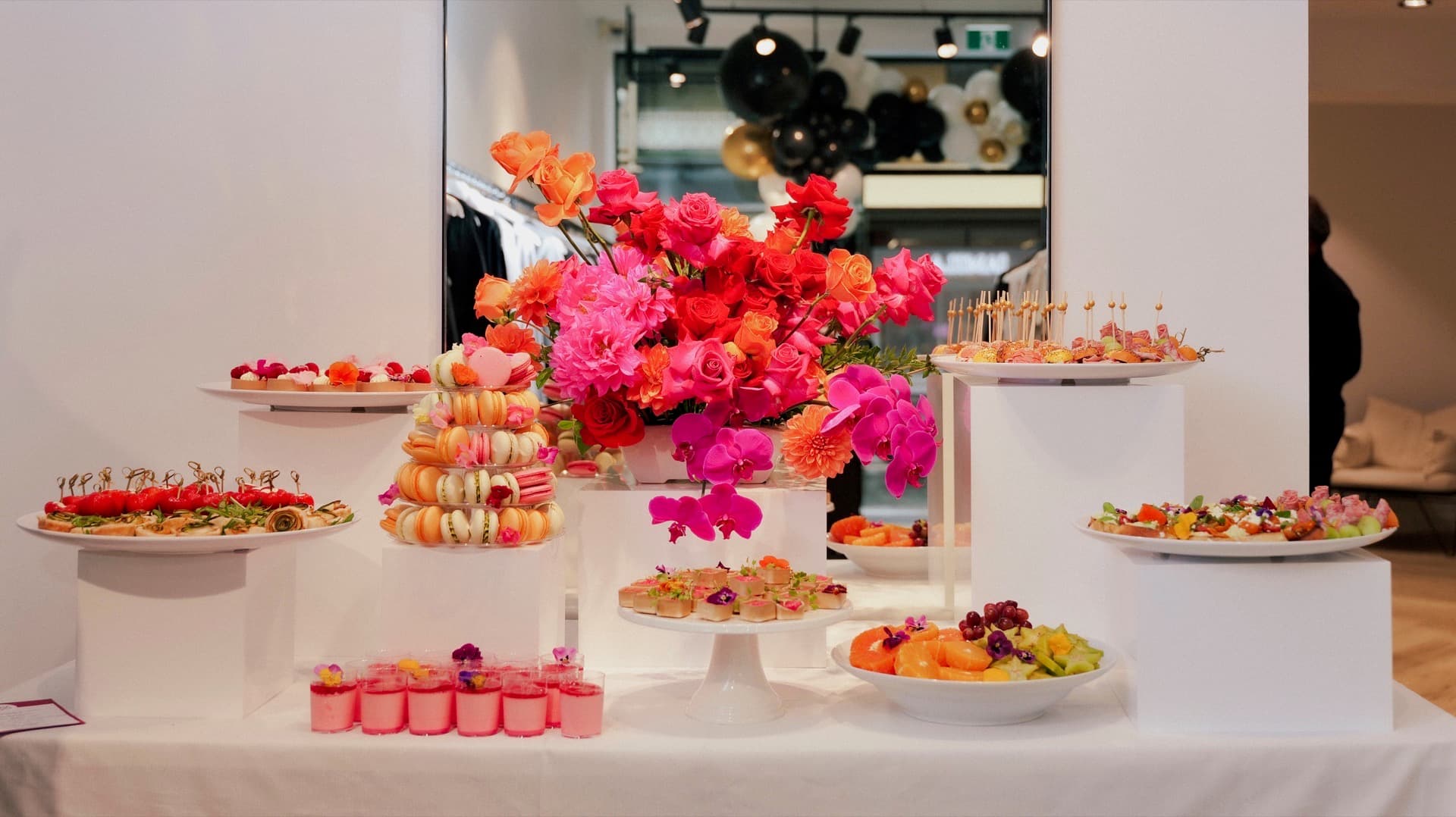 Adelaide corporate event display with macarons, canapes, and coral florals